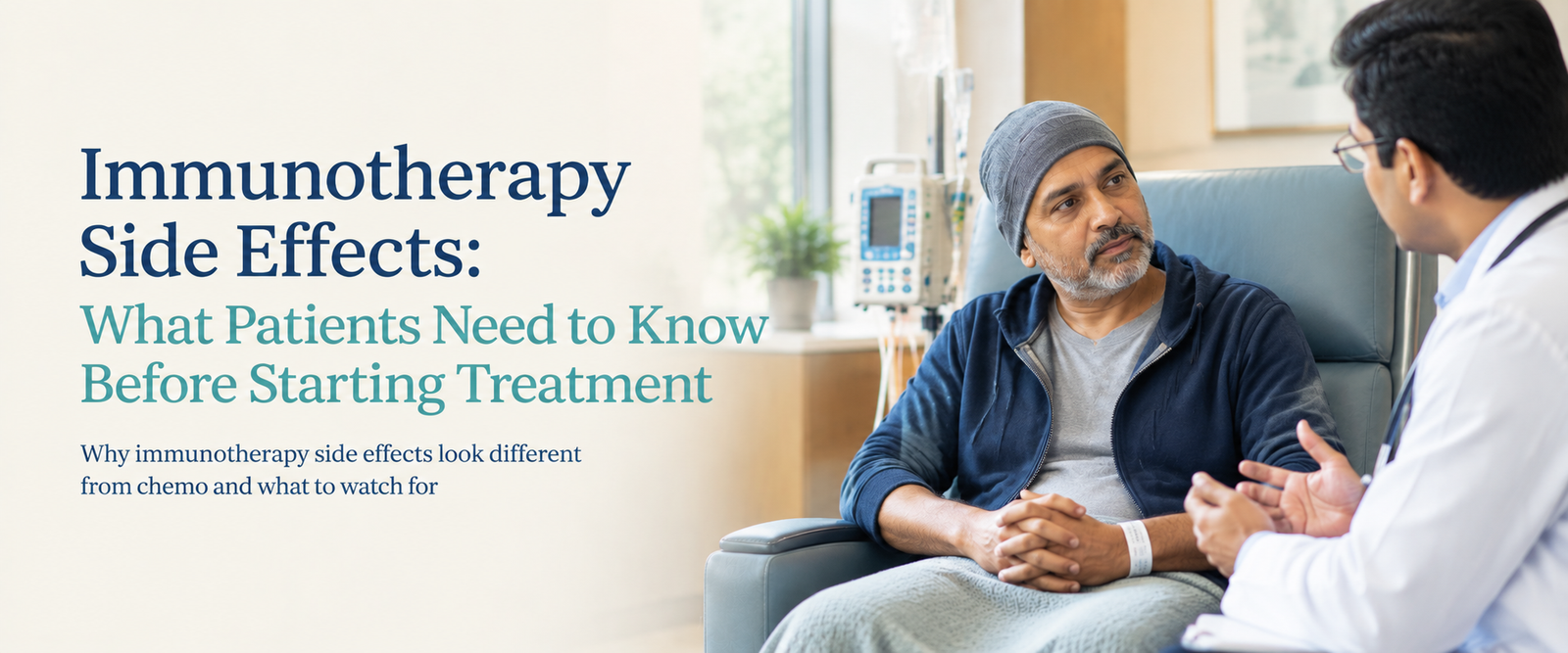 Middle-aged Indian man seated in a hospital chair having a focused conversation with a male doctor in a softly lit cancer-care setting, with an infusion pump in the background.